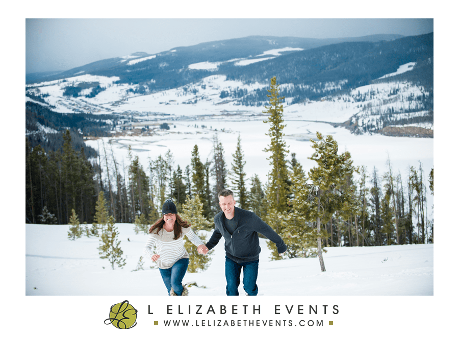 couple running in the snow in the colorado mountains, breckenridge proposal photographer