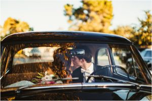 bride and groom kissing, scottsdale wedding planner, getaway car, vintage ford