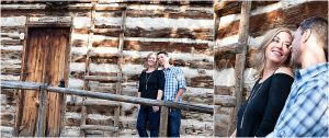 couple in front of historic wooden cabin,clear creek history park, golden colorado engagement session, autumn, l elizabeth events, colorado engagement photography, mountain engagement photographer