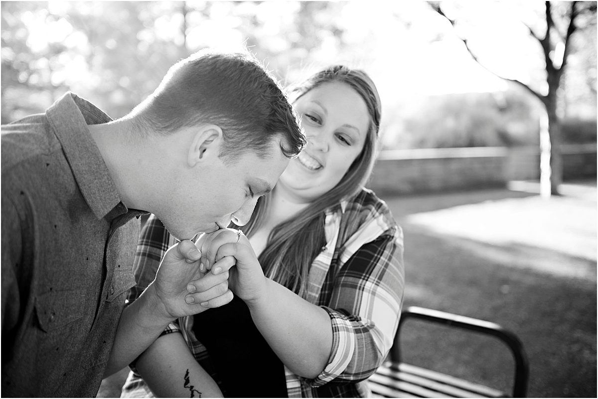 guy kissing girl's hand, Denver Engagement Session, Commons Park, Millennium Bridge, Colorado Engagement Photographer, black and white portrait