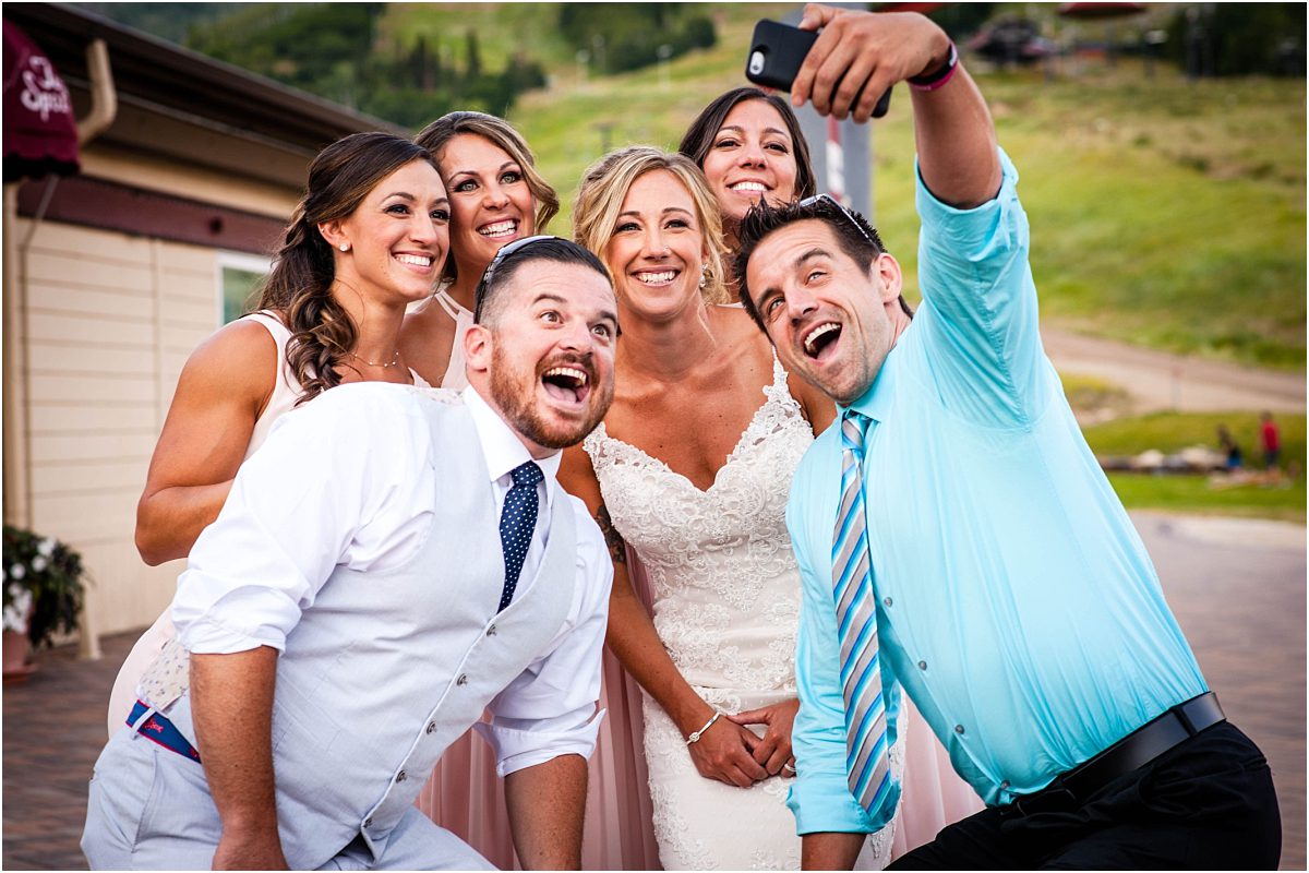 wedding guests taking selfie with bride, wedding reception, steamboat springs resort, colorado wedding photographer