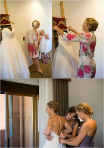 bride getting ready, putting on the dress, bridesmaids, floral robes,wedding day, clear creek history park, golden, colorado wedding planner, mountain wedding photographer, hotel room, table mountain inn