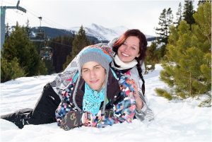 couple laying in the snow,winter snowboarding proposal, beaver run resort, surprise proposal, colorado photographer, proposal photography, mountain wedding photographer, summit county