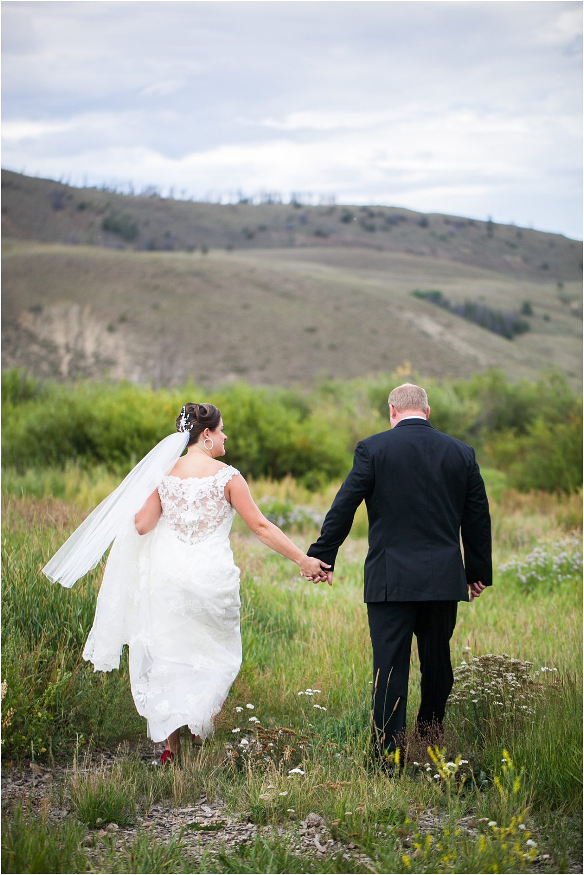 bride and groom walking holding hands,C Lazy U Ranch, Granby, Colorado, Rustic Ranch Wedding, Colorado Wedding Planner, Mountain Wedding Photographer