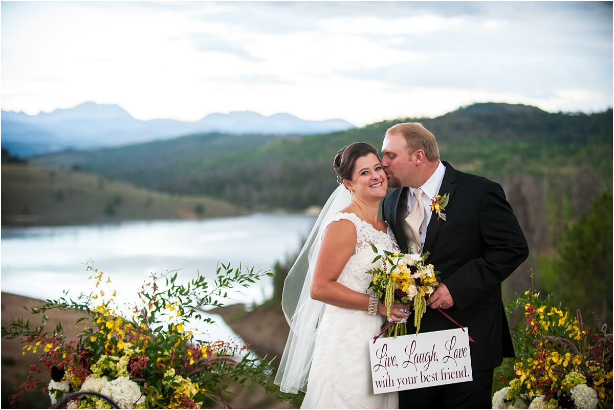 bride and groom with sign, couples portraits, mountain lake view,C Lazy U Ranch, Granby, Colorado, Rustic Ranch Wedding, Colorado Wedding Planner, Mountain Wedding Photographer
