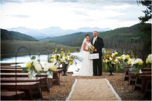 bride and groom portrait with sign at ceremony site, mountain lake view,C Lazy U Ranch, Granby, Colorado, Rustic Ranch Wedding, Colorado Wedding Planner, Mountain Wedding Photographer