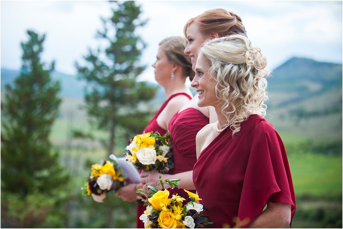 bridesmaids standing at ceremony during processional,C Lazy U Ranch, Granby, Colorado, Rustic Ranch Wedding, Colorado Wedding Planner, Mountain Wedding Photographer, outdoor ceremony, woodsie ceremony site