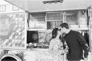 couple kissing in front of aioli gourmet burgers truck,hotel valley ho, scottsdale, arizona, styled shoot, engagement session, food trucks, wedding weekend, pool party, phoenix wedding planner, event design, black and white image
