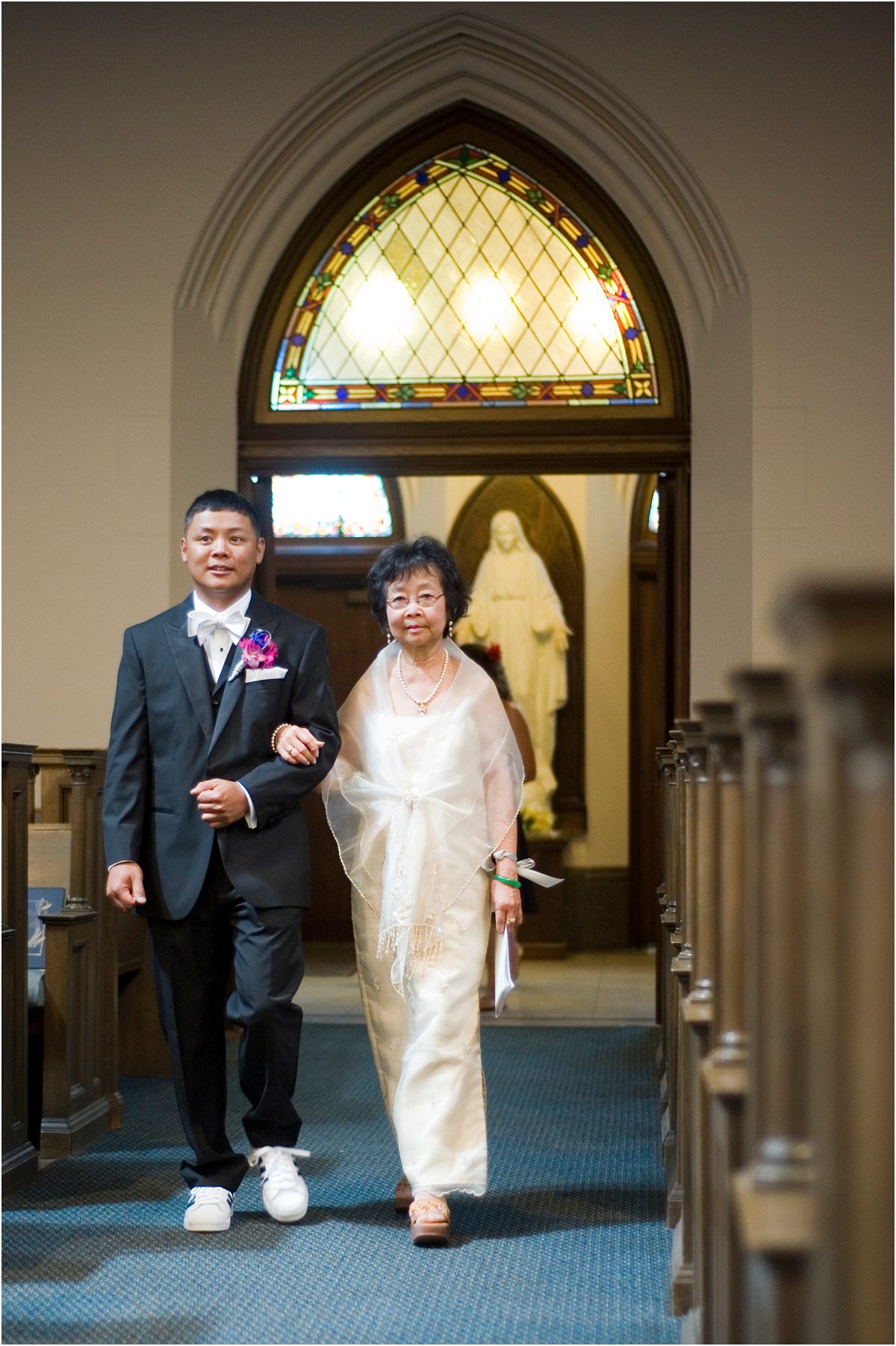 processional, mother of the groom and groom walking down the aisle, filipino,catholic church, ceremony, colorado wedding photographer