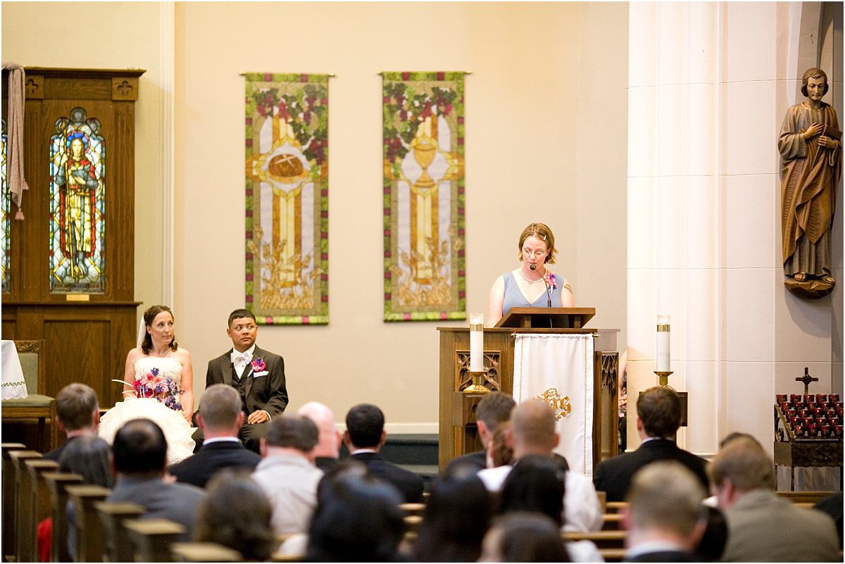ceremony reading, bride and groom seated on the altar,catholic church, ceremony, colorado wedding photographer