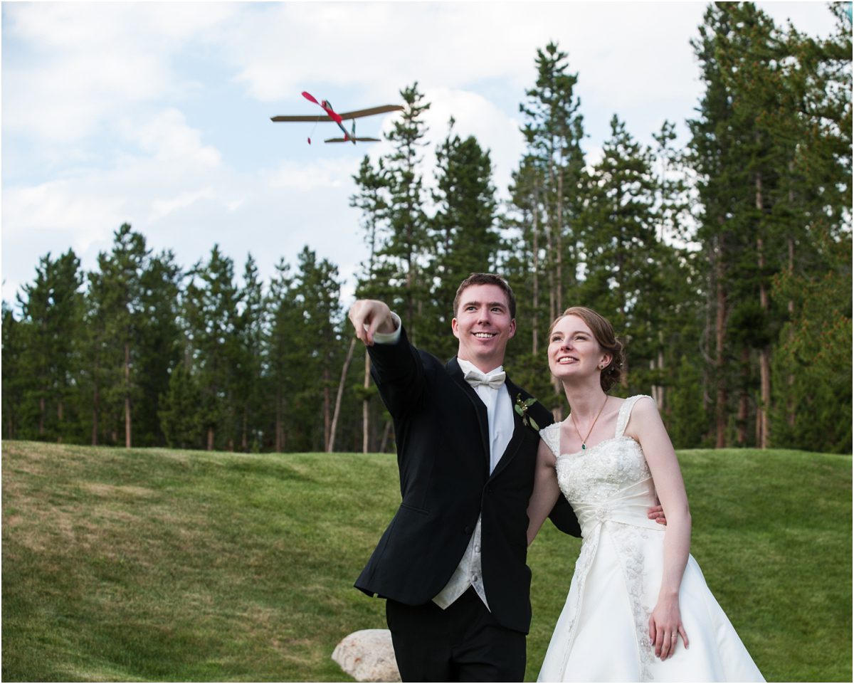 bride and groom portraits, flying airplane, keystone ranch wedding photography, mountain wedding planning