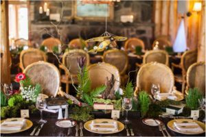 forest theme tablescape, wood chairs, flying bi-plane, ferns, wood, literary inspired table design, keystone ranch