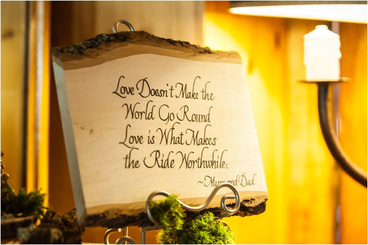 wood slab poem, quote on wood, love doesn't make the world go round love is what makes the ride worthwhile, love quote, forest themed wedding