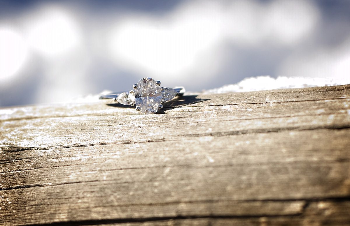 wedding ring on wood log, engagement planning tips
