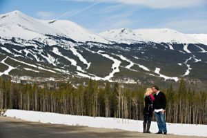 couple kissing behind ski resort, proposal tip 6
