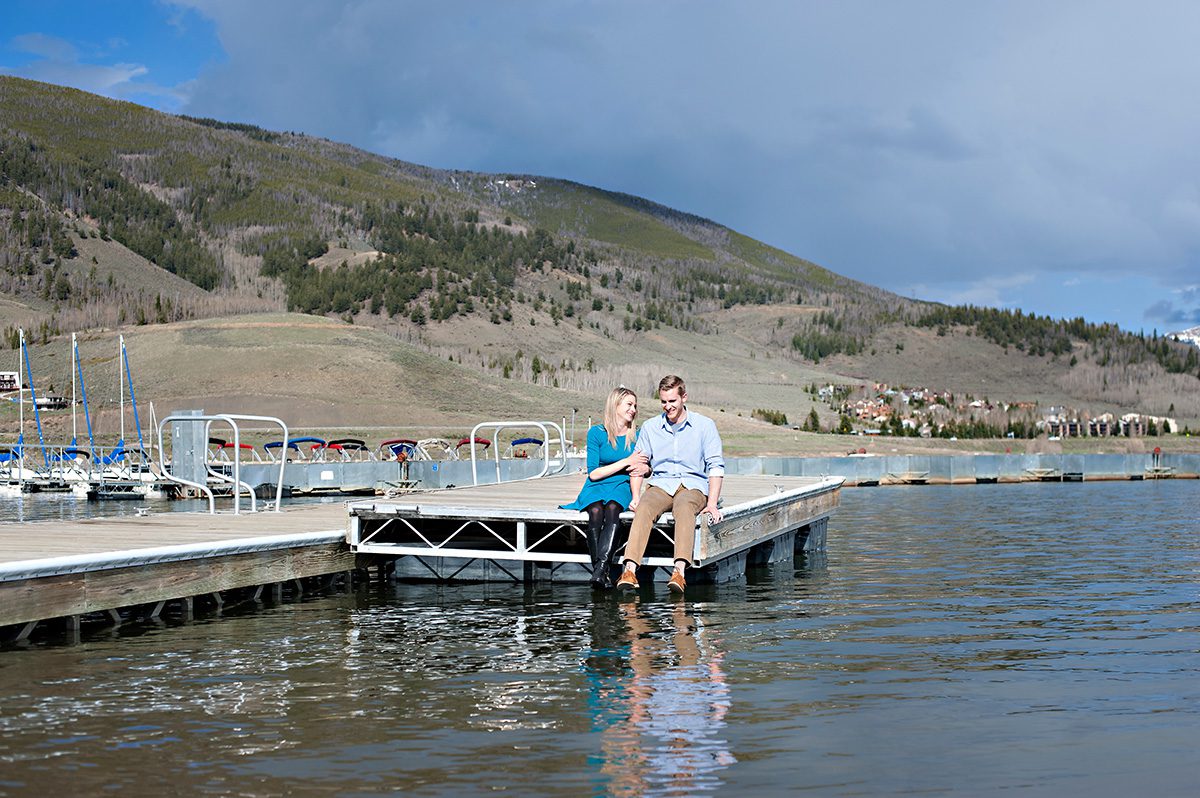 couple sitting on a dock, proposal tip 4, destination wedding planner, marriage proposal