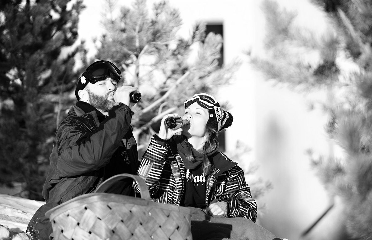 couple sipping champagne on the slopes, proposal tip 7, engagement tips from destination wedding planner