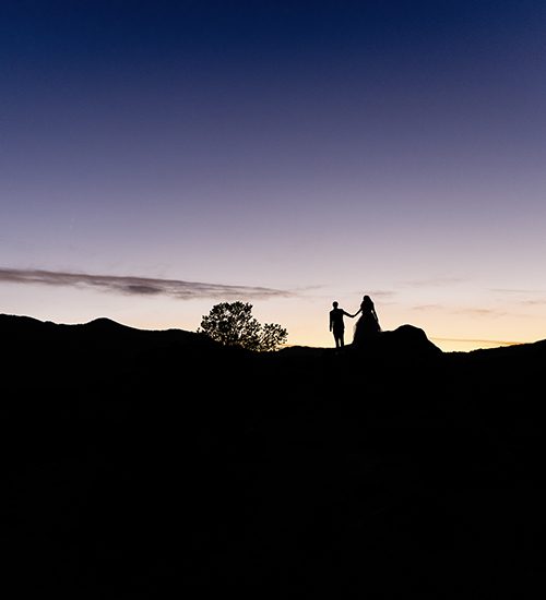 silhouette of a couple on a mountain